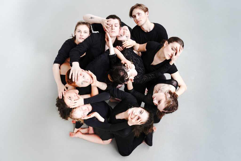 Aerial shot of an expressive dance group forming a circle in a studio setting in Hamburg.